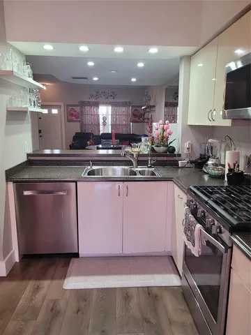 a kitchen with a sink stove and cabinets