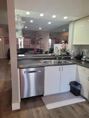 a kitchen with stainless steel appliances granite countertop a sink and a stove