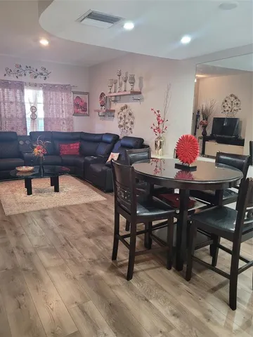 a living room with furniture a rug and white walls