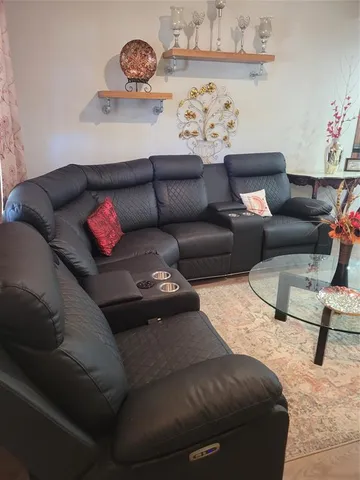 a living room with furniture and a wall