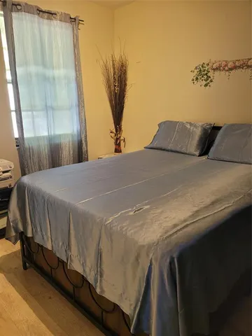 a bed sitting in a bedroom next to a window