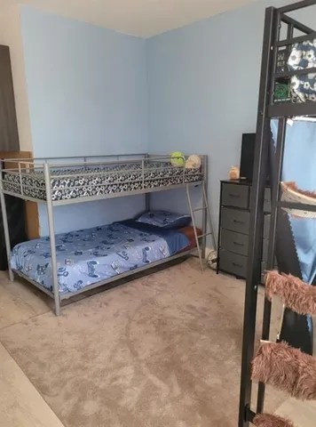 a view of a bedroom with a bed and furniture