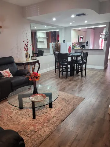 a living room with furniture and a dining area