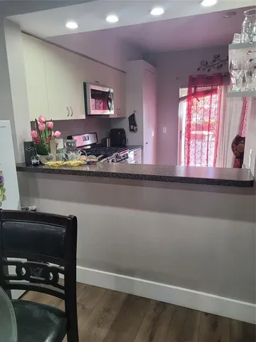 a kitchen with a refrigerator and a stove