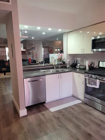 a kitchen with granite countertop a sink and cabinets