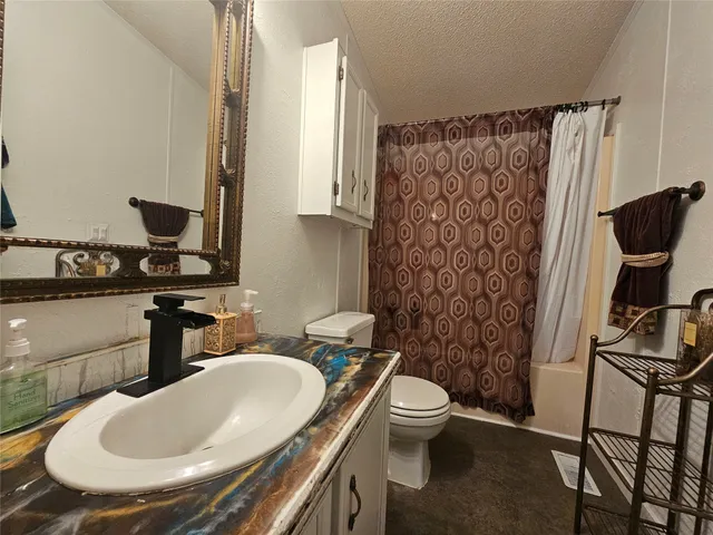 a bathroom with a sink toilet and a mirror