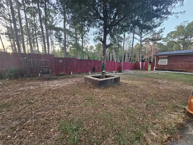 a view of a backyard with plants and outdoor seating