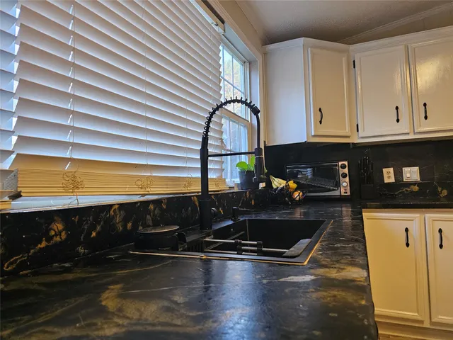 a kitchen with a sink and cabinets