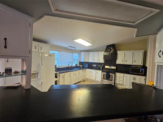 a kitchen with stainless steel appliances a refrigerator and a sink