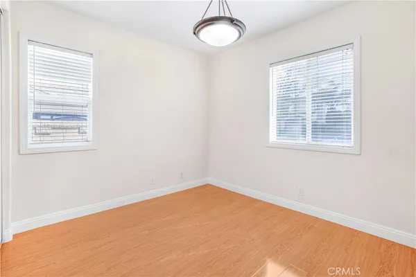 a view of a room with a window and wooden floor