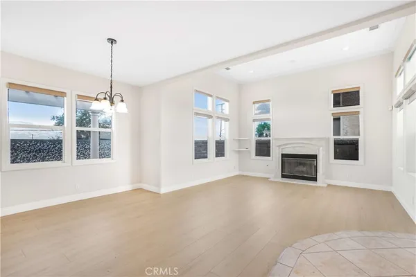 a view of an empty room with a fireplace and a window