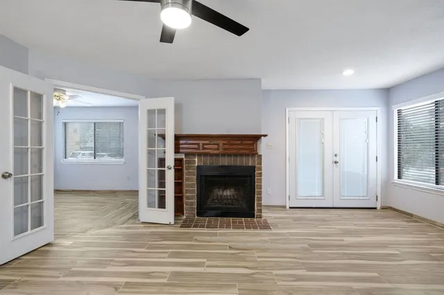an empty room with fireplace and windows