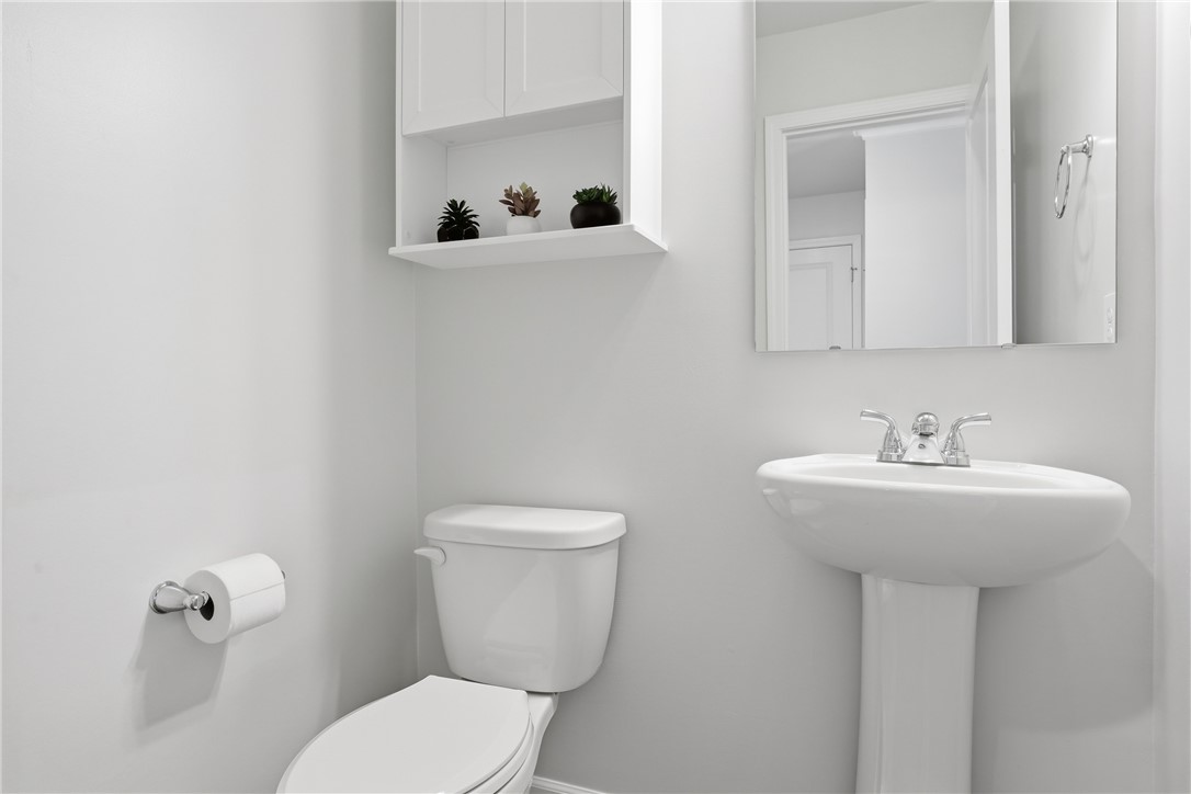 36 Chalet Court Anderson, SC 29621 - Photo 11 of 30 This bright bathroom features a pedestal sink and toilet, offering a clean and functional design.