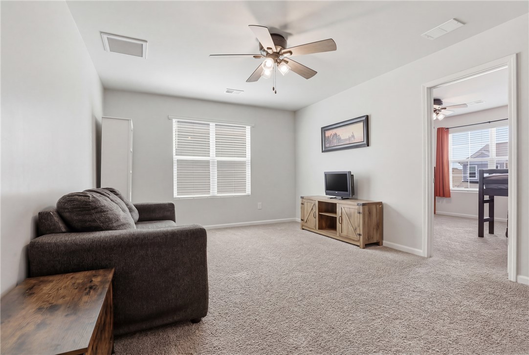 36 Chalet Court Anderson, SC 29621 - Photo 12 of 30 Bright and airy living area featuring a ceiling fan, plush carpet, and ample natural light.