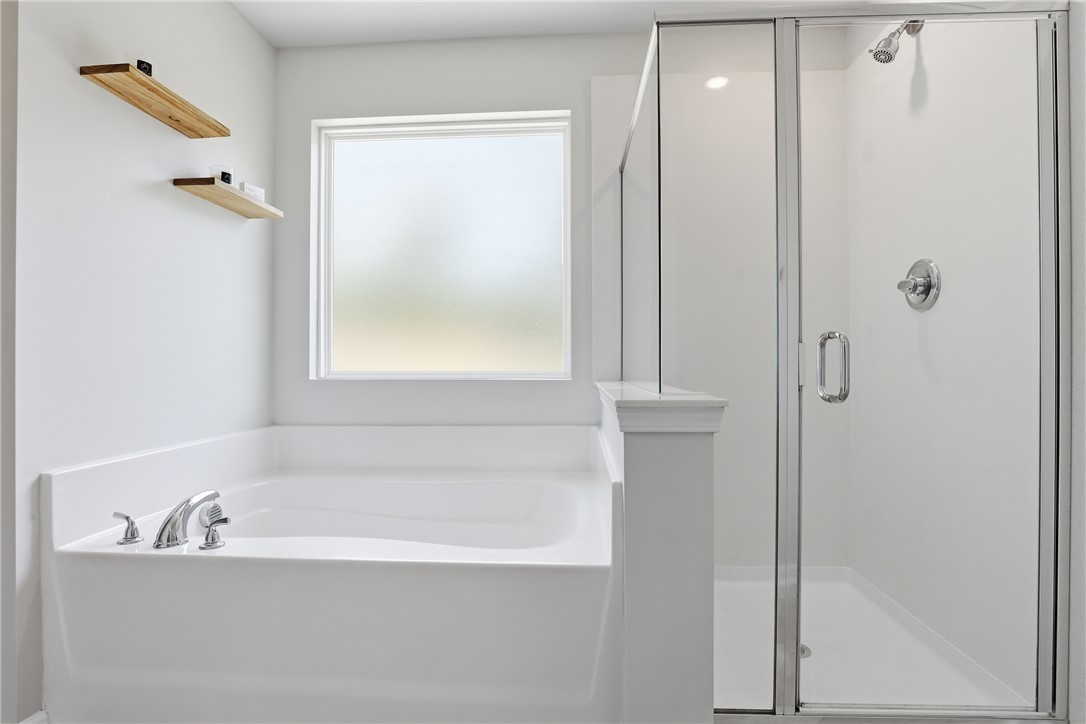 36 Chalet Court Anderson, SC 29621 - Photo 17 of 30 Bright and airy, this bathroom offers a pristine soaking tub and a spacious glass-enclosed shower.