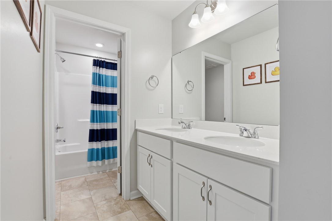 36 Chalet Court Anderson, SC 29621 - Photo 20 of 30 This bathroom features a double vanity and a shower-tub combination, providing practical elegance.