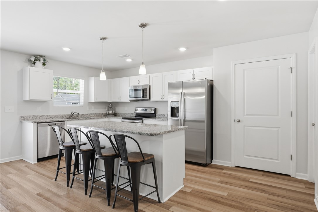 36 Chalet Court Anderson, SC 29621 - Photo 8 of 30 Bright and open, this modern kitchen features an island with seating and sleek appliances.