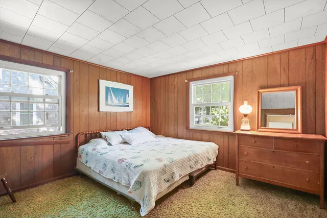 a bedroom with a bed and window