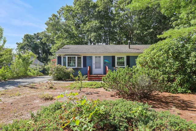 a front view of a house with a garden
