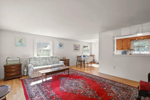 a living room with furniture a rug and a table