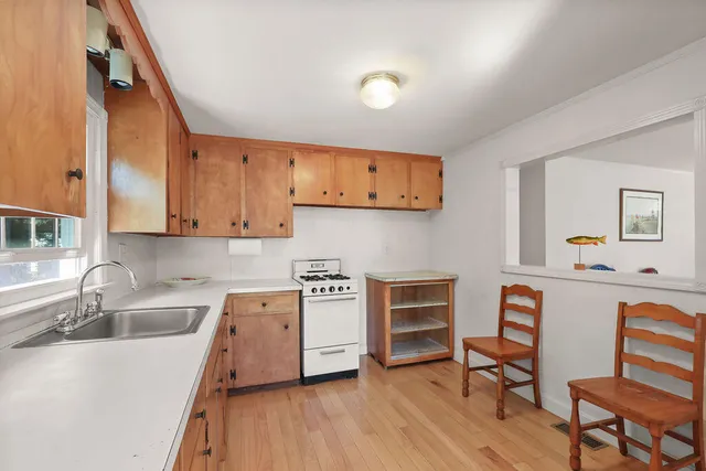 a kitchen with stainless steel appliances granite countertop a sink stove and cabinets