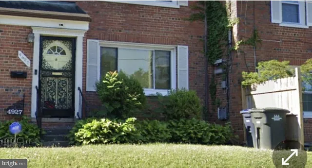 a view of a house with potted plants