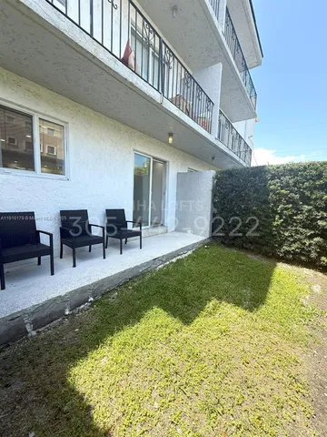 a view of a house with swimming pool and sitting area