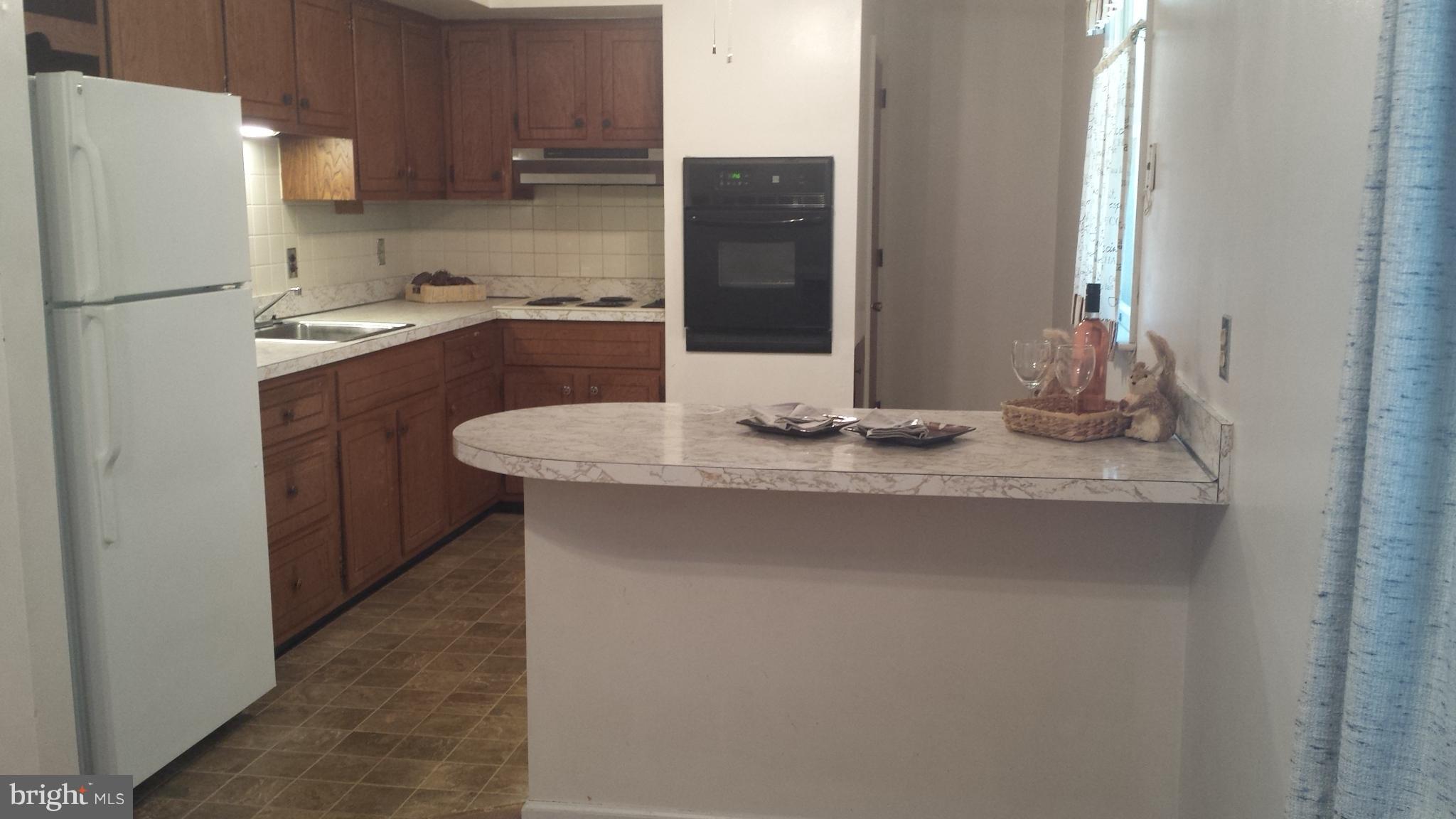 621 Edgewood Road Edgewood, MD 21040 - Photo 5 of 19 a kitchen with stainless steel appliances granite countertop a sink and a refrigerator