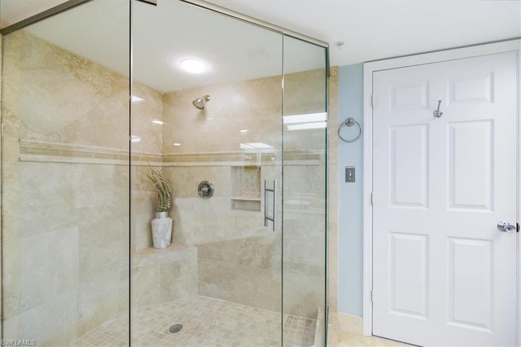 21 Bluebill Avenue, Unit B806 Naples, FL 34108 - Photo 15 of 22 a bathroom with a glass shower door