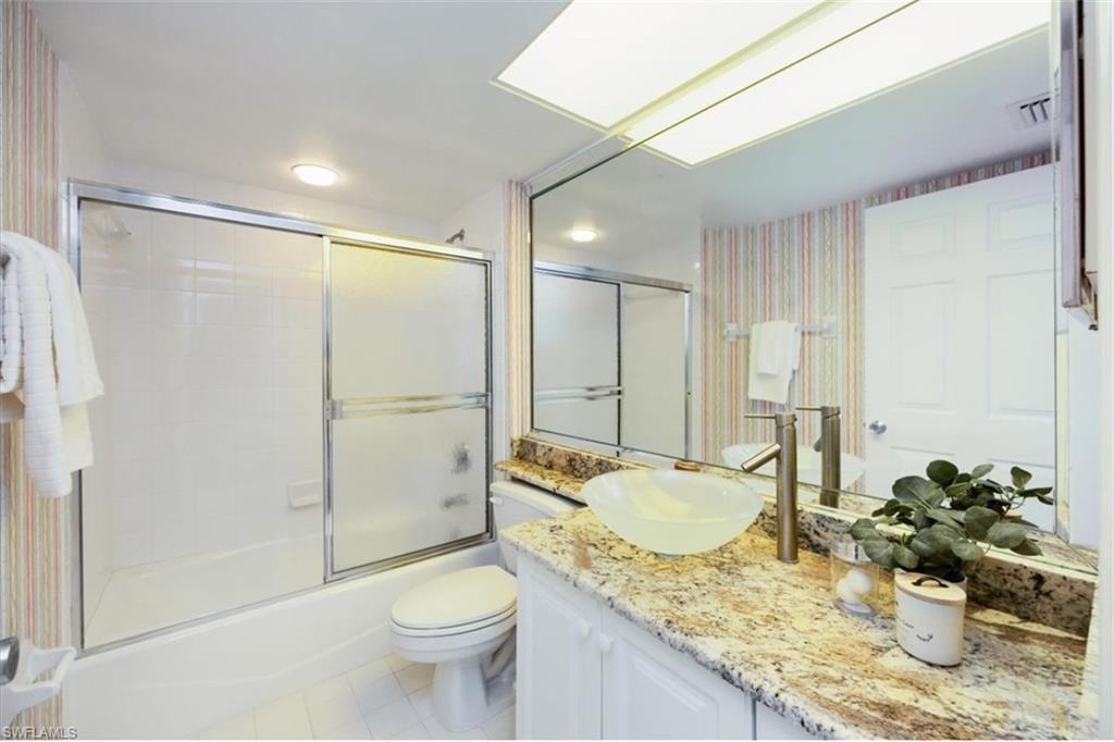 21 Bluebill Avenue, Unit B806 Naples, FL 34108 - Photo 17 of 22 a bathroom with a granite countertop sink toilet and shower