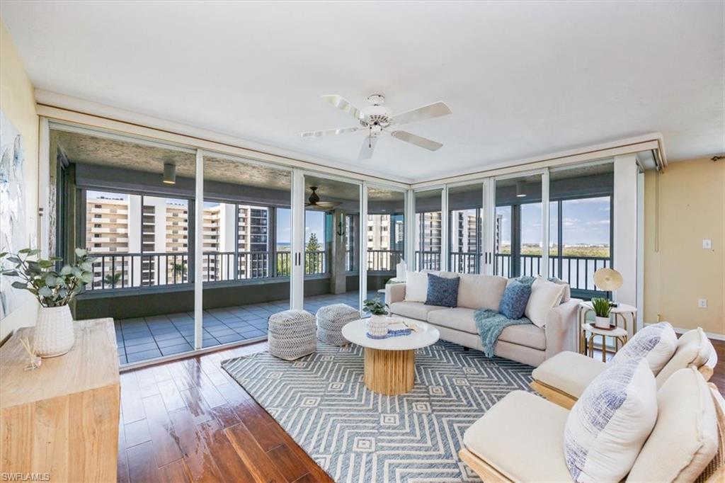 21 Bluebill Avenue, Unit B806 Naples, FL 34108 - Photo 5 of 22 a living room with furniture and a large window with balcony view