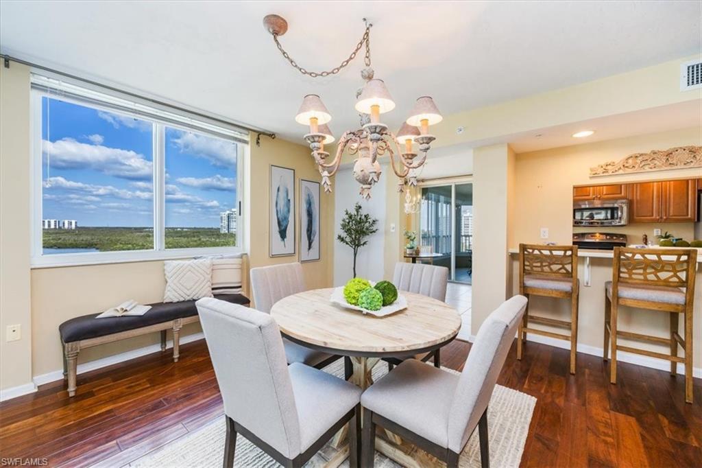 21 Bluebill Avenue, Unit B806 Naples, FL 34108 - Photo 8 of 22 a view of a dining room with furniture window and wooden floor