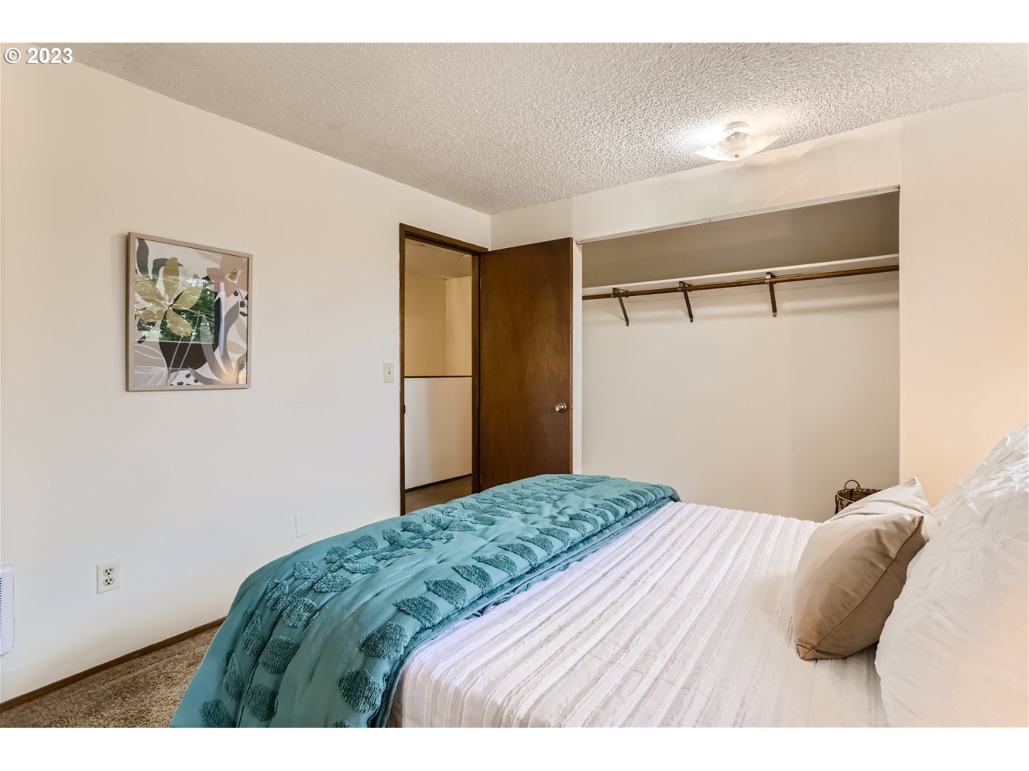 7410 South Virginia Avenue Portland, OR 97219 - Photo 16 of 27 a bedroom with a bed and a painting on the wall
