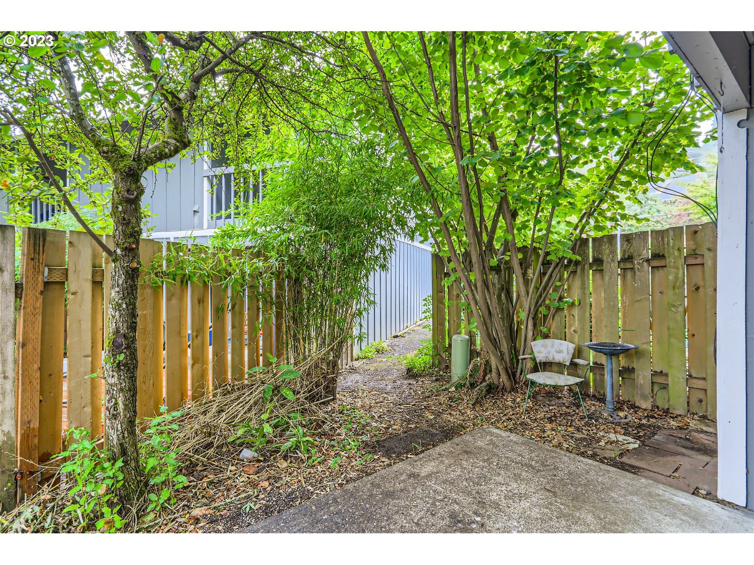 7410 South Virginia Avenue Portland, OR 97219 - Photo 24 of 27 a backyard of a house with outdoor seating
