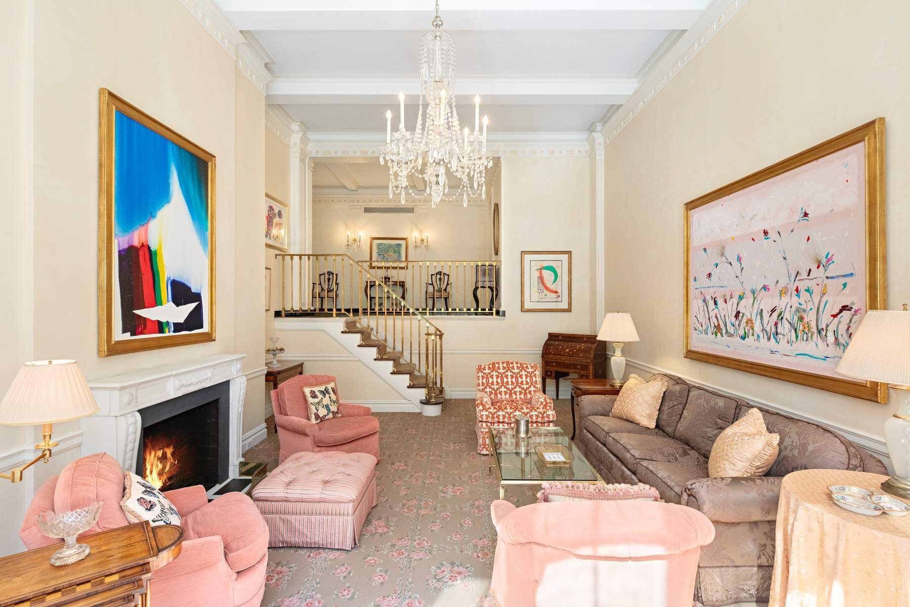 14 East 75th Street, Unit 4A Manhattan, NY 10021 - Photo 3 of 12 a living room with furniture a chandelier and a fireplace