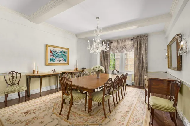 a living room with furniture a chandelier and a fireplace
