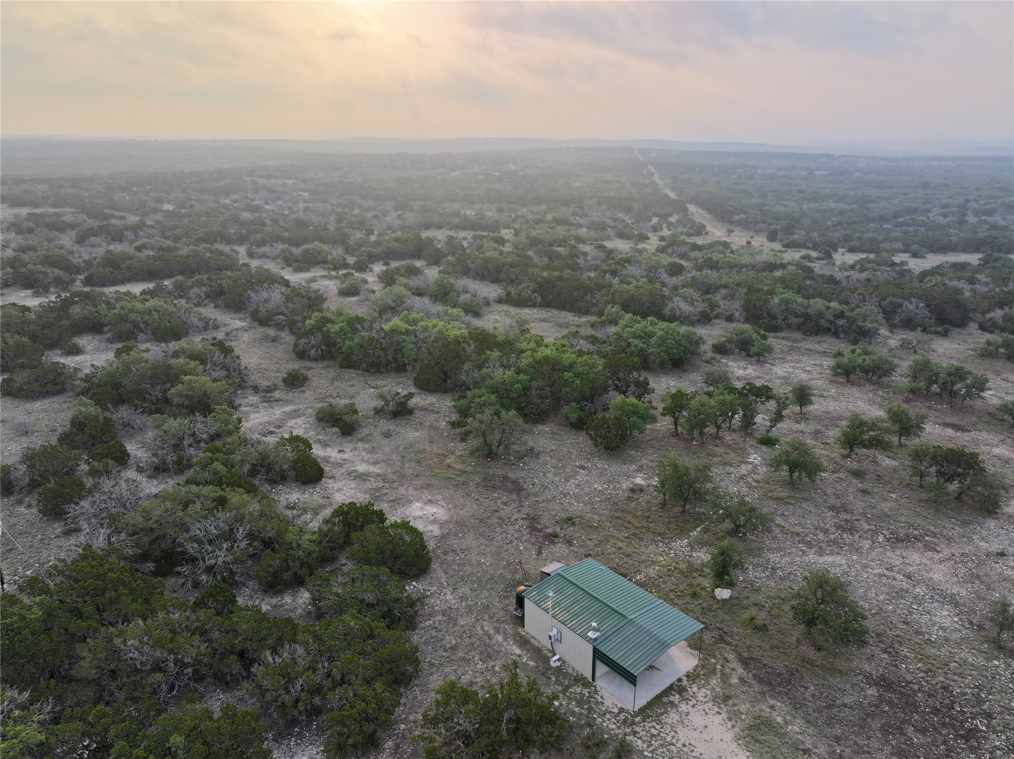 an aerial view of house with yard and mountain view in back