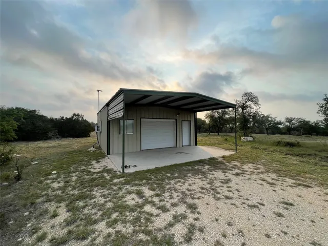 a view of a dry yard with lots of green space