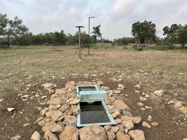 a view of a small house with a yard