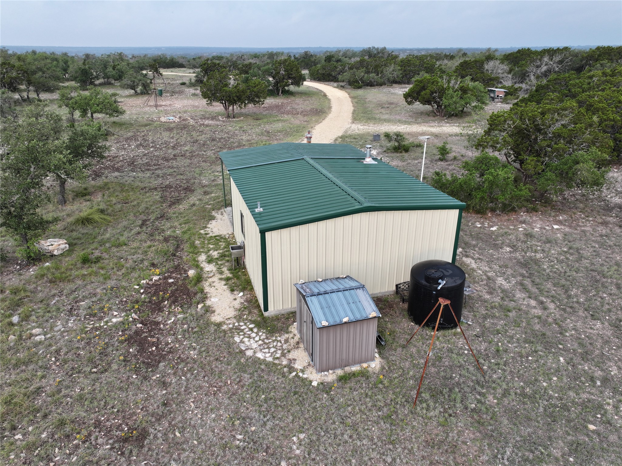 220 Rattlesnake Road Northwest Junction, TX 76849 - Photo 26 of 38 an aerial view of a house having yard