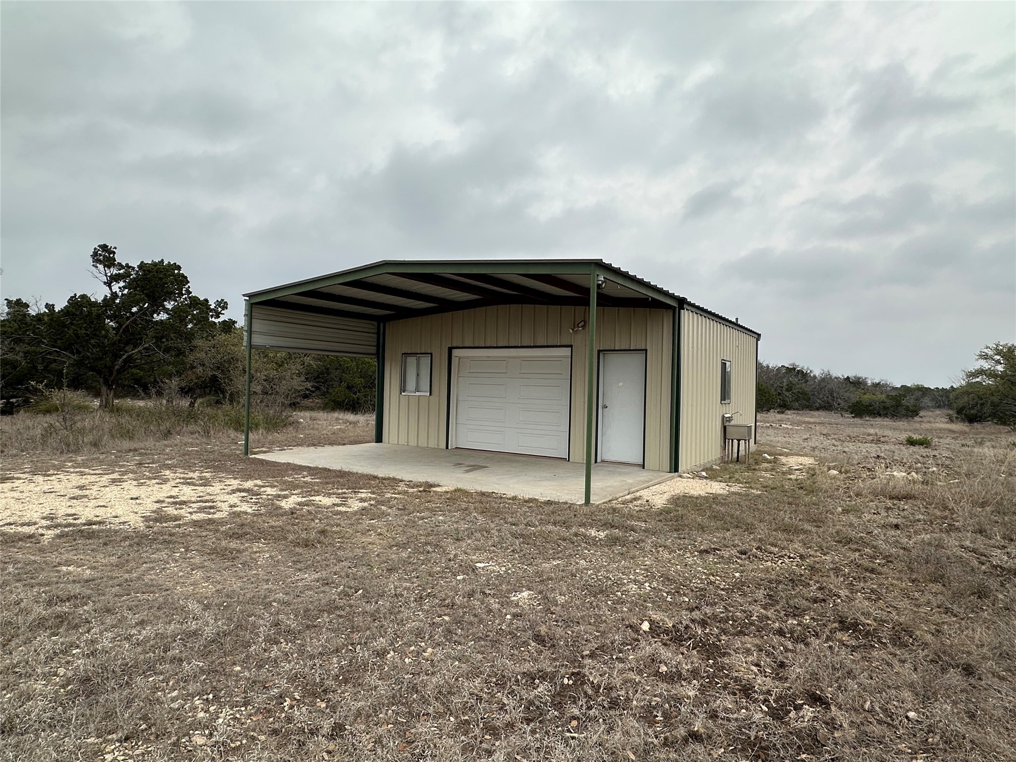220 Rattlesnake Road Northwest Junction, TX 76849 - Photo 3 of 38 a backyard of a house with lots of green space