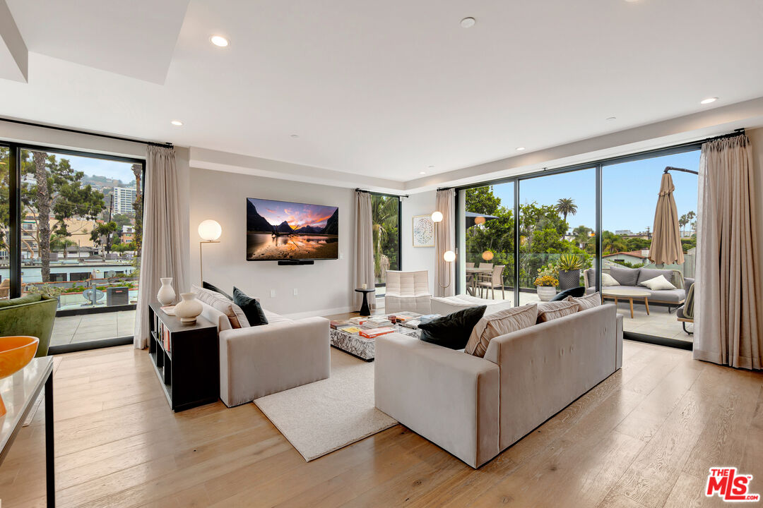 1017 North Croft Avenue, Unit PH1 Los Angeles, CA 90069 - Photo 12 of 34 a living room with furniture and a large window