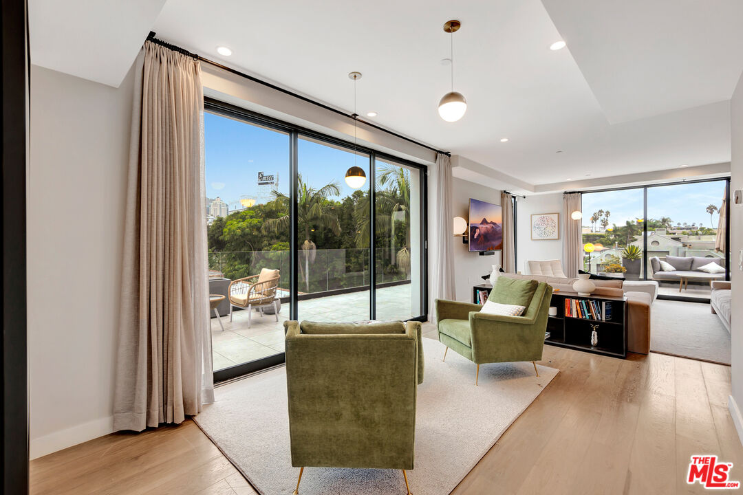 1017 North Croft Avenue, Unit PH1 Los Angeles, CA 90069 - Photo 15 of 34 a living room with furniture large window and wooden floor