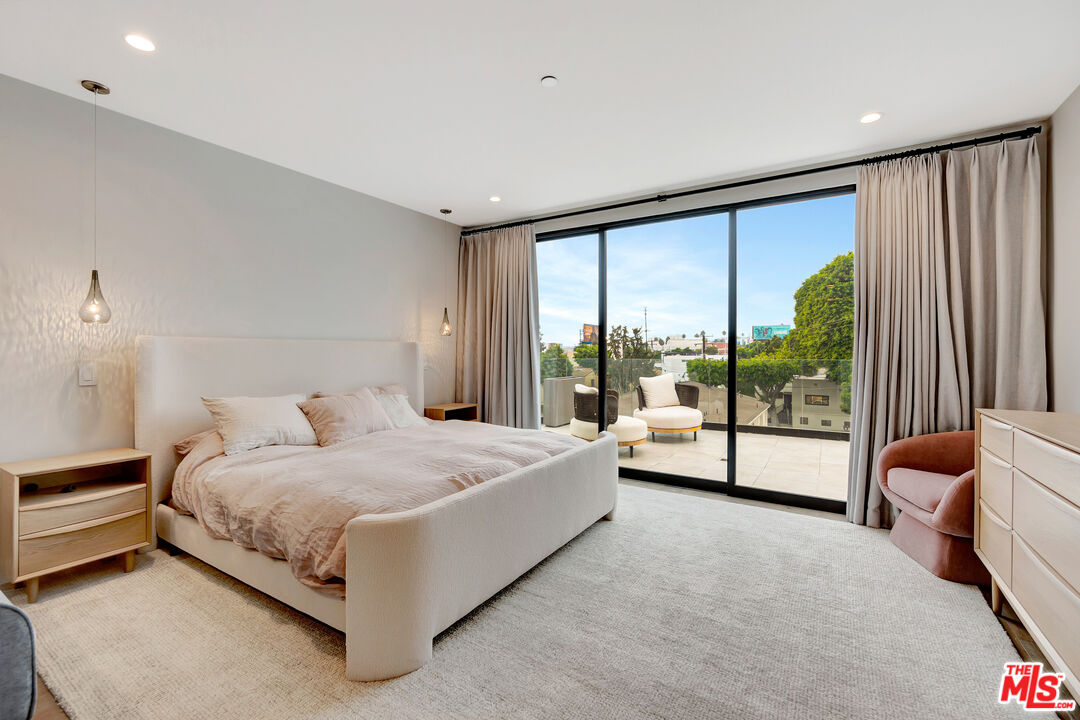 1017 North Croft Avenue, Unit PH1 Los Angeles, CA 90069 - Photo 17 of 34 a spacious bedroom with a bed and large window