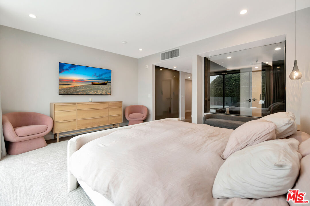 1017 North Croft Avenue, Unit PH1 Los Angeles, CA 90069 - Photo 18 of 34 a bedroom with a bed and glass walk in closet