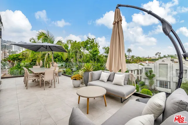 a outdoor living space with furniture the view and a floor to ceiling window