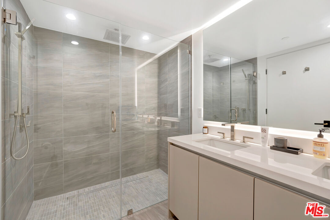 1017 North Croft Avenue, Unit PH1 Los Angeles, CA 90069 - Photo 22 of 34 a bathroom with a double vanity sink mirror and shower