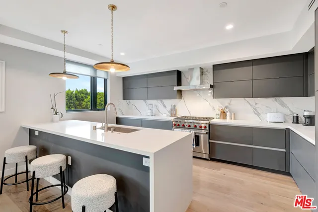 a kitchen with a sink cabinets and window