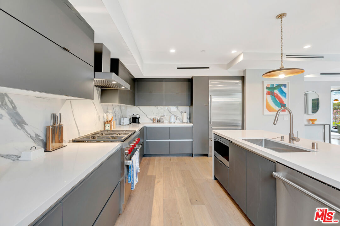 1017 North Croft Avenue, Unit PH1 Los Angeles, CA 90069 - Photo 4 of 34 a kitchen with stainless steel appliances a sink a stove a refrigerator and cabinets
