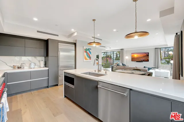 a kitchen with stainless steel appliances a sink stove and refrigerator